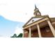 Classic church exterior with detailed columns and steeple against a blue sky with white clouds at 2704 Fairview Rd, Raleigh, NC 27608