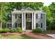 Charming two-story home with a brick walkway, black shutters, and manicured landscaping at 2704 Fairview Rd, Raleigh, NC 27608