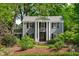 Charming two-story home with a brick walkway, black shutters, and mature trees at 2704 Fairview Rd, Raleigh, NC 27608