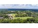 Aerial view of a lush golf course with mature trees and manicured greens on a sunny day with blue skies at 2704 Fairview Rd, Raleigh, NC 27608