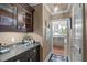 Hallway featuring a built-in bar and glimpse of kitchen with hardwood flooring and neutral walls at 2704 Fairview Rd, Raleigh, NC 27608