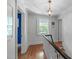 Upstairs hallway featuring beautiful hardwood floors, chandelier and natural light at 2704 Fairview Rd, Raleigh, NC 27608