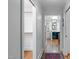 Hallway view with closet space leading to a bathroom featuring hardwood floors at 2704 Fairview Rd, Raleigh, NC 27608