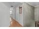Upstairs hallway with hardwood floors leading to an adjacent living space at 2704 Fairview Rd, Raleigh, NC 27608