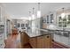 Spacious kitchen island with stainless steel sink and modern pendant lighting, seamlessly flowing into living space at 2704 Fairview Rd, Raleigh, NC 27608