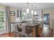 Bright kitchen featuring custom white cabinets, a large island, and stainless steel appliances at 2704 Fairview Rd, Raleigh, NC 27608