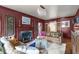 Cozy living room with dark walls, fireplace, hardwood floors, and stylish furniture at 2704 Fairview Rd, Raleigh, NC 27608