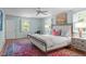 Relaxing main bedroom with a ceiling fan, windows and a decorative rug with bed at 2704 Fairview Rd, Raleigh, NC 27608