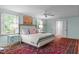 Comfortable main bedroom with a ceiling fan, windows and a decorative rug with bed at 2704 Fairview Rd, Raleigh, NC 27608