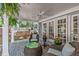 Relaxing covered patio with wicker furniture, brick flooring, ceiling fan, and view of the backyard at 2704 Fairview Rd, Raleigh, NC 27608