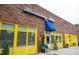 Bloomsbury Bistro brick exterior with yellow trim, signage, and curated landscaping at 2704 Fairview Rd, Raleigh, NC 27608