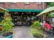Exterior view of Lilly's Pizza with outdoor seating under string lights and umbrellas at 2704 Fairview Rd, Raleigh, NC 27608