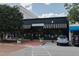 Retail exterior of Steven Shell Living with black and white awnings, parked cars, and street view at 2704 Fairview Rd, Raleigh, NC 27608