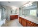 Elegant bathroom featuring double vanities, large mirrors, and a glass-enclosed shower for a spa-like experience at 2711 Laurelcherry St, Raleigh, NC 27612