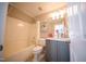 Cozy bathroom with tub-shower combo, vanity, and a brightly colored flamingo painting at 2711 Laurelcherry St, Raleigh, NC 27612