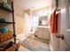 Modern bathroom featuring tub-shower combo, decorative shelving, and a colorful rug at 2711 Laurelcherry St, Raleigh, NC 27612