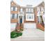Charming brick townhouse with an attached garage and landscaped front steps at 2711 Laurelcherry St, Raleigh, NC 27612