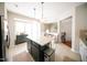 Open kitchen layout with an island, granite countertops, and stainless steel refrigerator at 2711 Laurelcherry St, Raleigh, NC 27612