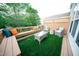 Relaxing patio with wicker furniture, artificial turf, and a charming outdoor space at 2711 Laurelcherry St, Raleigh, NC 27612