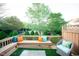 Inviting patio with bench seating, colorful pillows, and well-maintained landscaping at 2711 Laurelcherry St, Raleigh, NC 27612