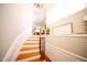 Elegant stairway featuring wood treads, white risers, and decorative iron railing at 2711 Laurelcherry St, Raleigh, NC 27612