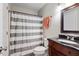 Clean bathroom featuring a dark vanity with granite countertop and a striped shower curtain at 294 Summerwalk Cir, Chapel Hill, NC 27517
