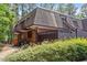 Charming townhome featuring a brick facade, cozy balcony, and lush green landscaping at 294 Summerwalk Cir, Chapel Hill, NC 27517