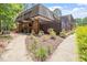 Exterior view of townhome with private wooden patio, surrounded by beautiful landscaping at 294 Summerwalk Cir, Chapel Hill, NC 27517