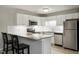 Modern kitchen with white cabinetry, granite countertops, and stainless steel appliances at 294 Summerwalk Cir, Chapel Hill, NC 27517