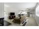 Open living space includes a ceiling fan and leads into a modern kitchen and laundry area at 294 Summerwalk Cir, Chapel Hill, NC 27517