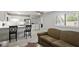 Combined living room and kitchen includes a sofa and kitchen chairs at 294 Summerwalk Cir, Chapel Hill, NC 27517
