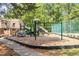 Community playground area with swings, slide, and climbing features at 294 Summerwalk Cir, Chapel Hill, NC 27517