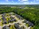 Scenic aerial view of homes near a pond, nestled amidst the green space and blue skies at 3029 Mountain Hill Dr, Wake Forest, NC 27587