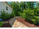 A walkway leads to outdoor seating in the serene and private backyard with manicured landscaping at 3029 Mountain Hill Dr, Wake Forest, NC 27587