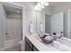 Bright bathroom with a walk-in shower, a toilet, a vanity, a mirror, and decorative baskets at 3029 Mountain Hill Dr, Wake Forest, NC 27587