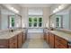En suite bathroom with double vanities and soaking tub overlooking the yard at 3029 Mountain Hill Dr, Wake Forest, NC 27587