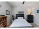 Comfortable bedroom with a black bed, a ceiling fan, and a bookshelf with books and decor at 3029 Mountain Hill Dr, Wake Forest, NC 27587