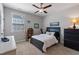 Neutral bedroom with a black bed, a ceiling fan, a window, and decorative items on display at 3029 Mountain Hill Dr, Wake Forest, NC 27587