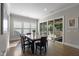 Sunlit dining area with hardwood floors, access to screened porch, and large windows offering natural light at 3029 Mountain Hill Dr, Wake Forest, NC 27587