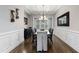 Bright dining room with coffered ceiling, hardwood floors, stylish chandelier, and elegant wainscoting at 3029 Mountain Hill Dr, Wake Forest, NC 27587