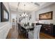Dining room featuring hardwood floors, coffered ceiling, elegant wainscoting, and access to the staircase at 3029 Mountain Hill Dr, Wake Forest, NC 27587