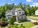 Attractive home showcasing a combination of stone and siding, complemented by a lush green lawn at 3029 Mountain Hill Dr, Wake Forest, NC 27587