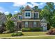 Beautiful two-story home featuring stone accents, manicured landscaping, and a charming covered entryway at 3029 Mountain Hill Dr, Wake Forest, NC 27587