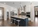 Modern kitchen featuring an island with seating, stainless steel appliances, and custom white cabinetry at 3029 Mountain Hill Dr, Wake Forest, NC 27587