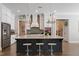 Modern kitchen featuring an island with seating, stainless steel appliances, and custom white cabinetry at 3029 Mountain Hill Dr, Wake Forest, NC 27587