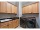 Laundry room features modern washer/dryer with wooden cabinets and granite countertops at 3029 Mountain Hill Dr, Wake Forest, NC 27587