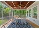 Inviting screened-in porch featuring rocking chairs, wood ceiling with fan, and views of the lush backyard at 3029 Mountain Hill Dr, Wake Forest, NC 27587