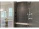 Walk-in shower featuring dark tile, shower head, and built-in bench at 3029 Mountain Hill Dr, Wake Forest, NC 27587