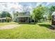 Expansive backyard featuring a screened-in patio, red outbuilding, and playground at 304 Cornelia Dr, Graham, NC 27253