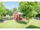 Backyard featuring a red outbuilding with white trim surrounded by green grass at 304 Cornelia Dr, Graham, NC 27253
